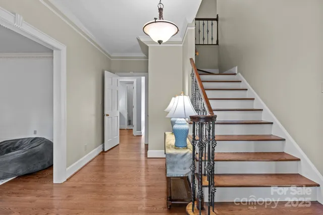a view of entryway and hall with wooden floor