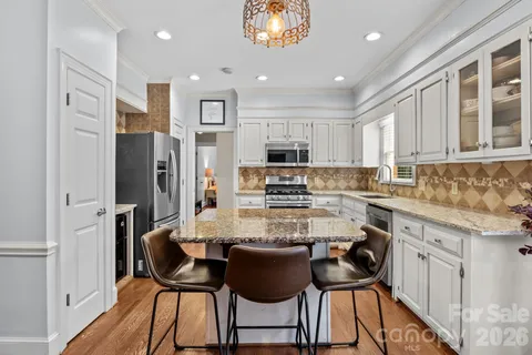 a view of living room with granite countertop furniture and wooden floor