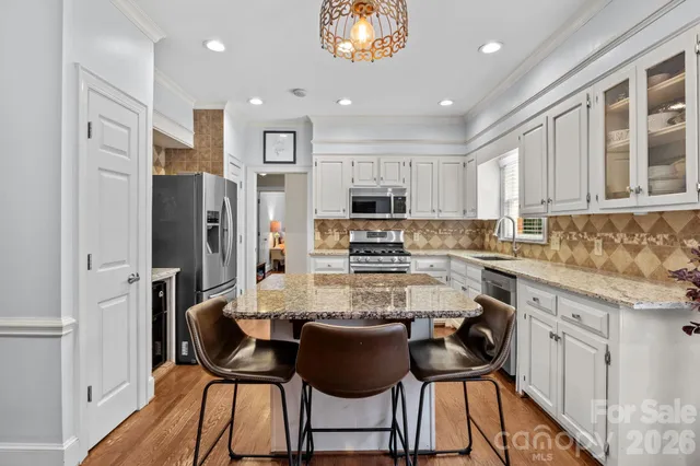 a view of living room with granite countertop furniture and wooden floor
