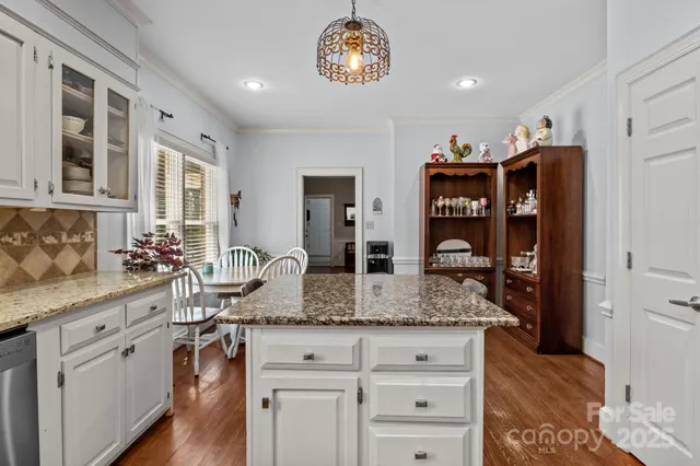 a view of living room with granite countertop furniture and wooden floor