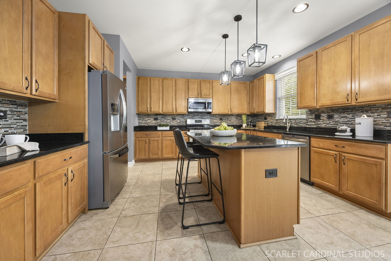 13905 Trillium Lane Plainfield, IL 60544 - Photo 13 of 30 a kitchen with stainless steel appliances granite countertop wooden cabinets a sink a stove and a refrigerator