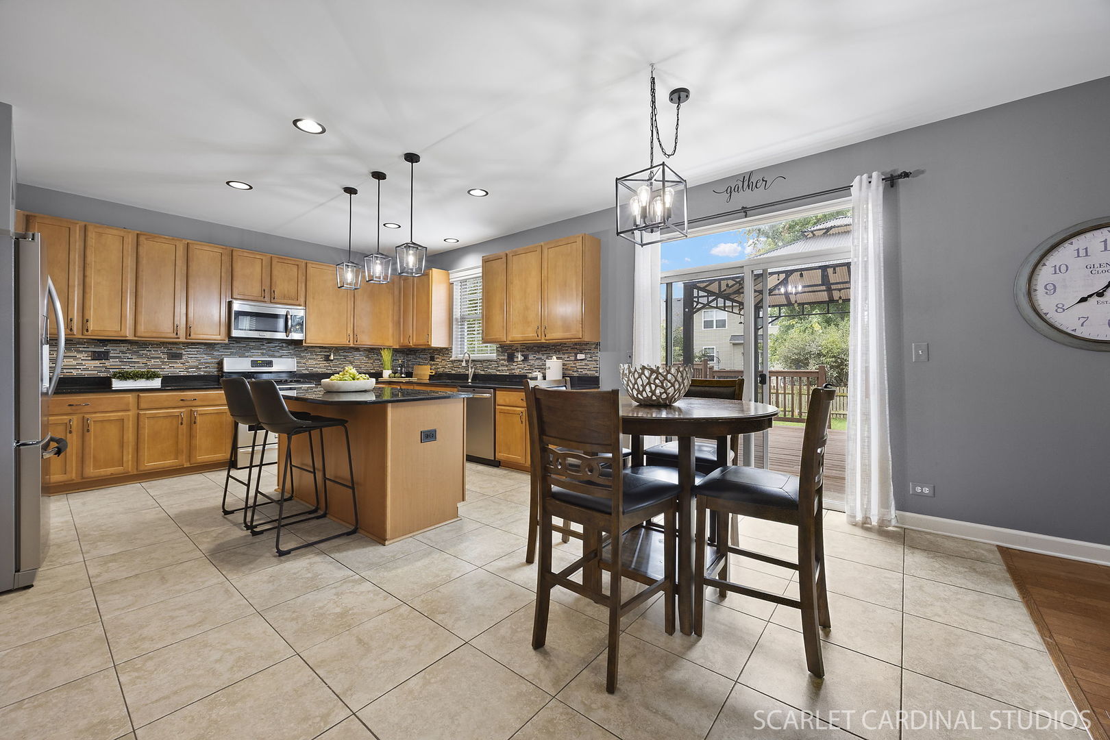 13905 Trillium Lane Plainfield, IL 60544 - Photo 14 of 30 a kitchen with stainless steel appliances granite countertop a stove a sink a microwave oven and a dining table