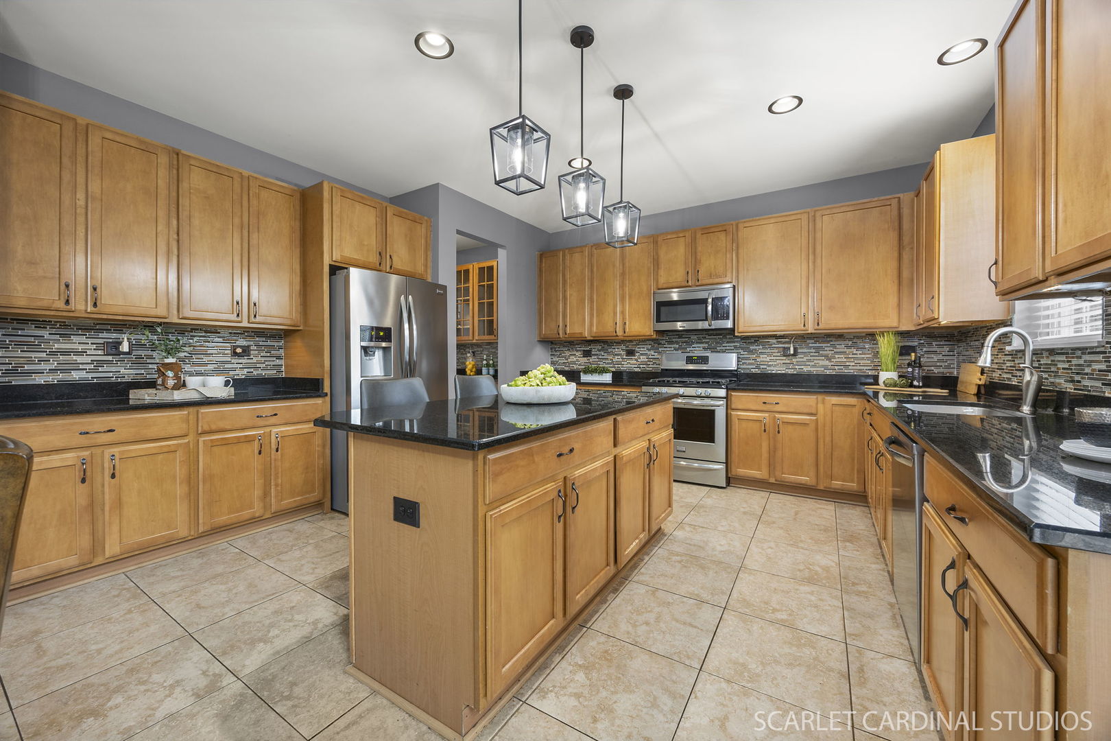 13905 Trillium Lane Plainfield, IL 60544 - Photo 15 of 30 a kitchen with stainless steel appliances granite countertop a stove top oven a refrigerator a sink and dishwasher with white cabinets