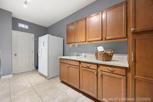 a kitchen with stainless steel appliances granite countertop a refrigerator and a cabinets