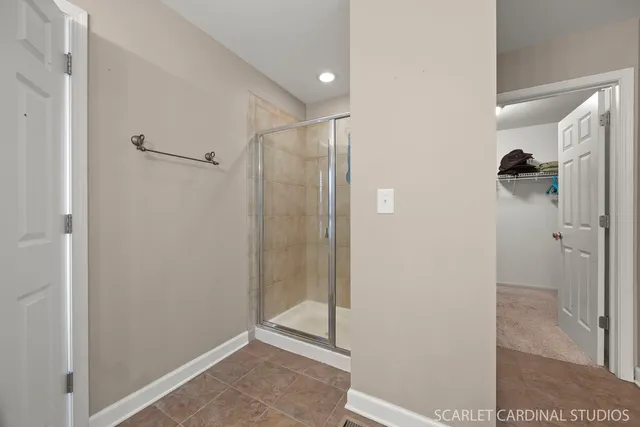 a bathroom with a shower and a glass door