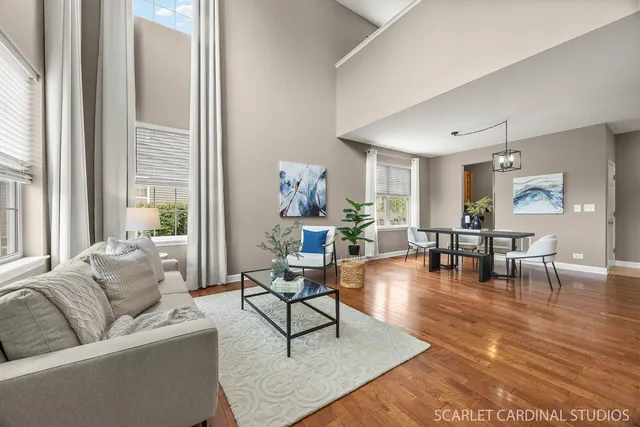 a living room with furniture and floor to ceiling windows