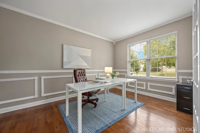 a workspace with wooden floor and a window