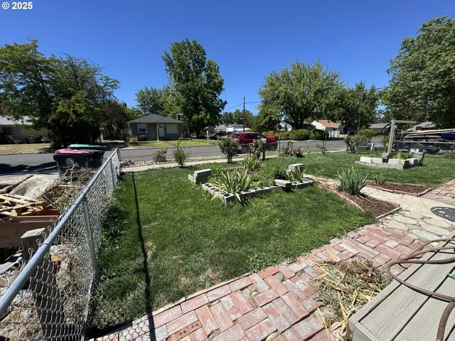 a view of a backyard with sitting area