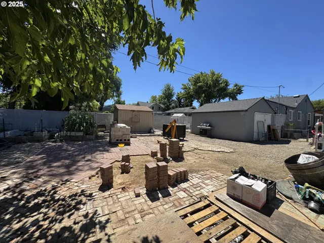 a view of backyard of house with seating space