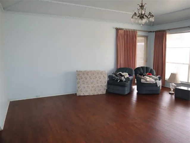 a room with furniture and floor to ceiling windows