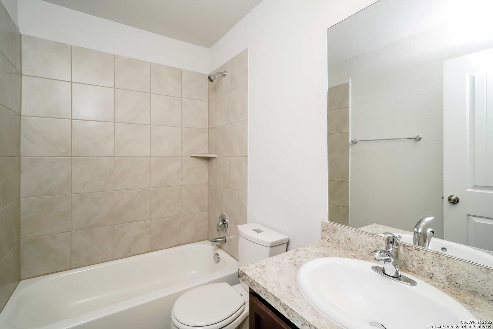 5122 Blue Ranch San Antonio, TX 78222 - Photo 9 of 16 a bathroom with a granite countertop sink toilet and bathtub