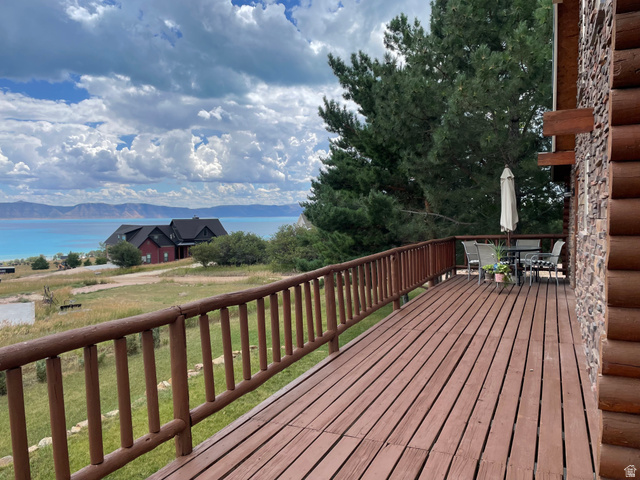 358 Maple Drive Fish Haven, ID 83287 - Photo 46 of 46 Expansive wood deck with a log railing, stone and log exterior, and mature trees