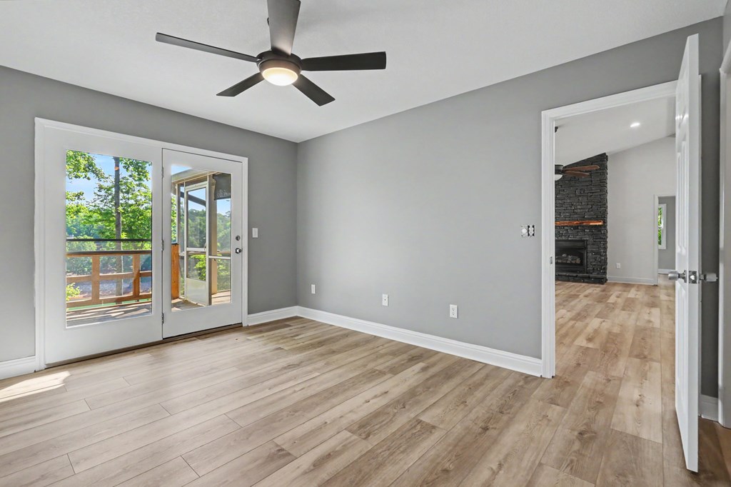456 Deaver Cove Road Blairsville, GA 30512 - Photo 25 of 83 a view of an empty room with wooden floor and a window