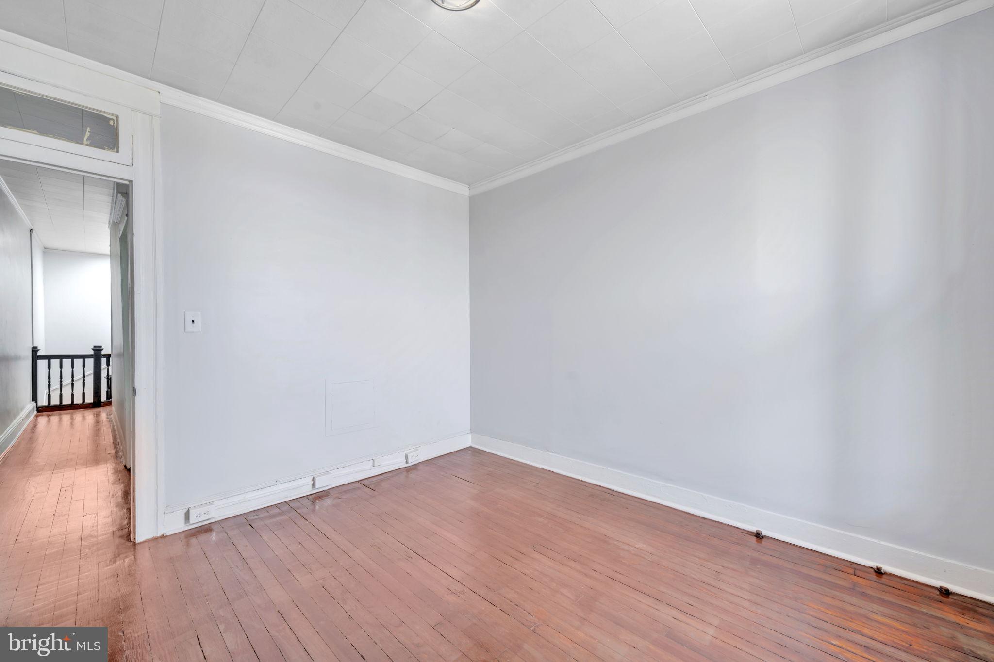 2822 Riggs Avenue Baltimore, MD 21216 - Photo 18 of 30 a view of an empty room with wooden floor