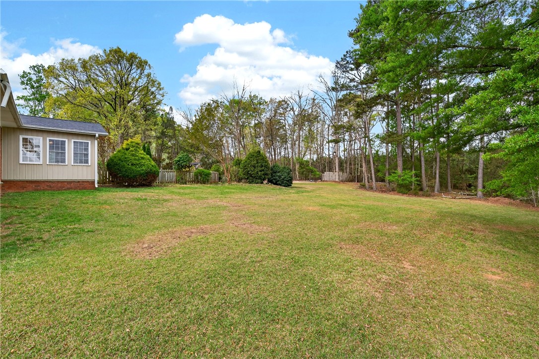 160 Burdette Circle Pendleton, SC 29670 - Photo 30 of 38 Expansive green yard with mature trees offers a serene backdrop for outdoor enjoyment.
