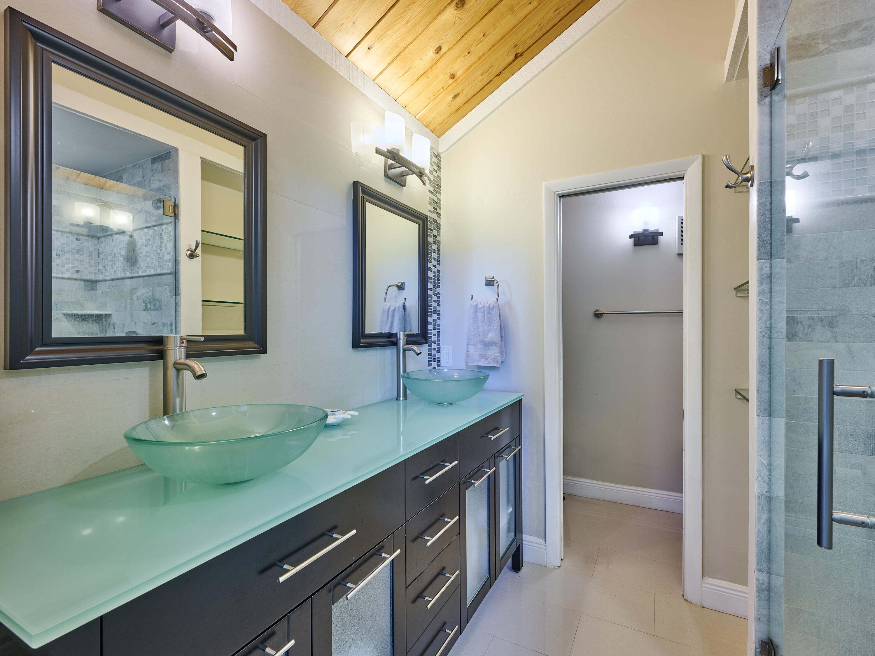 Undisclosed Address Jupiter, FL 33477 - Photo 14 of 20 a bathroom with a double vanity sink and a mirror