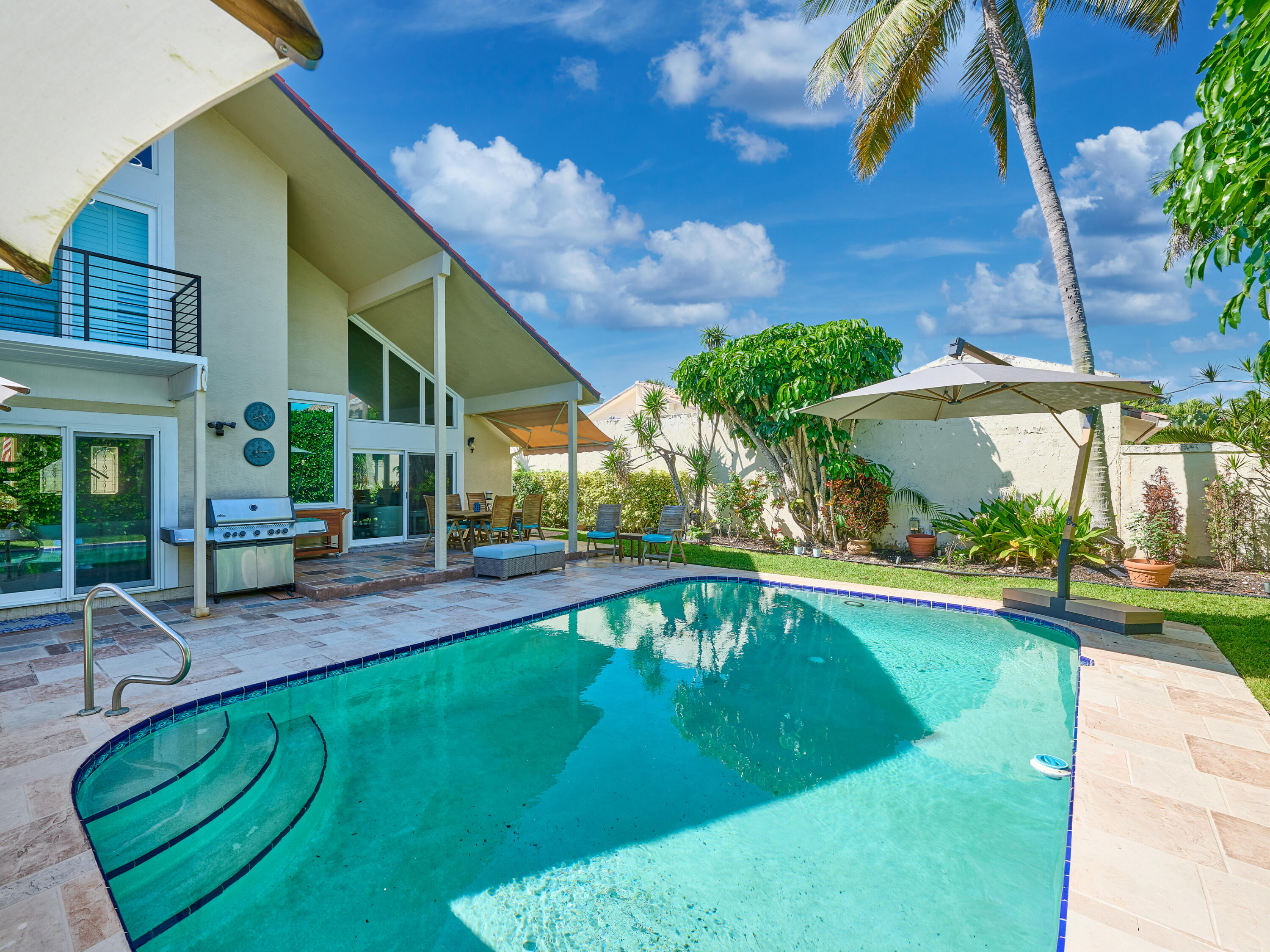 Undisclosed Address Jupiter, FL 33477 - Photo 18 of 20 a view of a house with a swimming pool