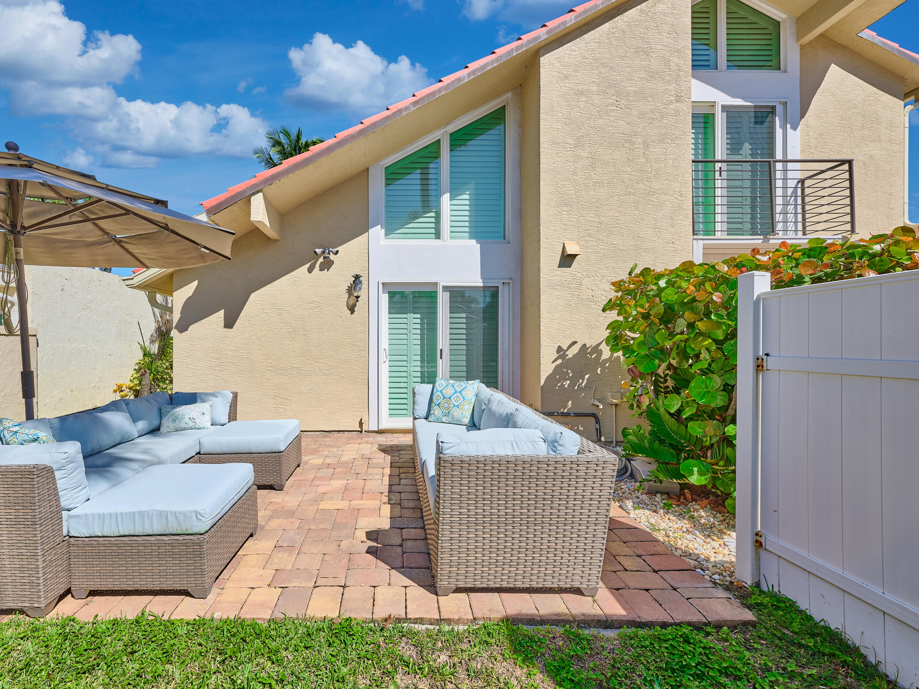 Undisclosed Address Jupiter, FL 33477 - Photo 20 of 20 a view of a house with couches and potted plants