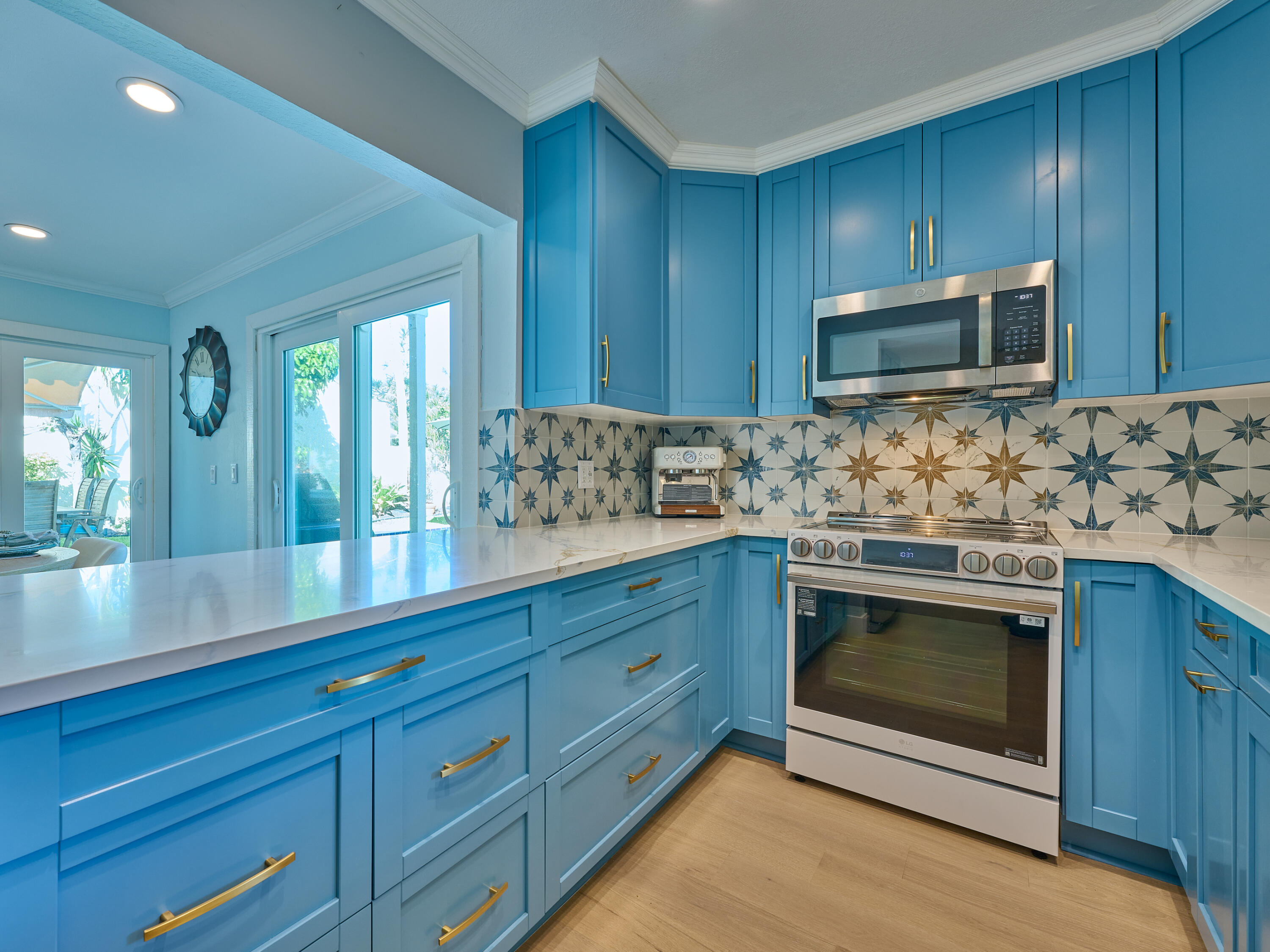 Undisclosed Address Jupiter, FL 33477 - Photo 7 of 20 a kitchen with stainless steel appliances granite countertop wooden cabinets and a stove top oven