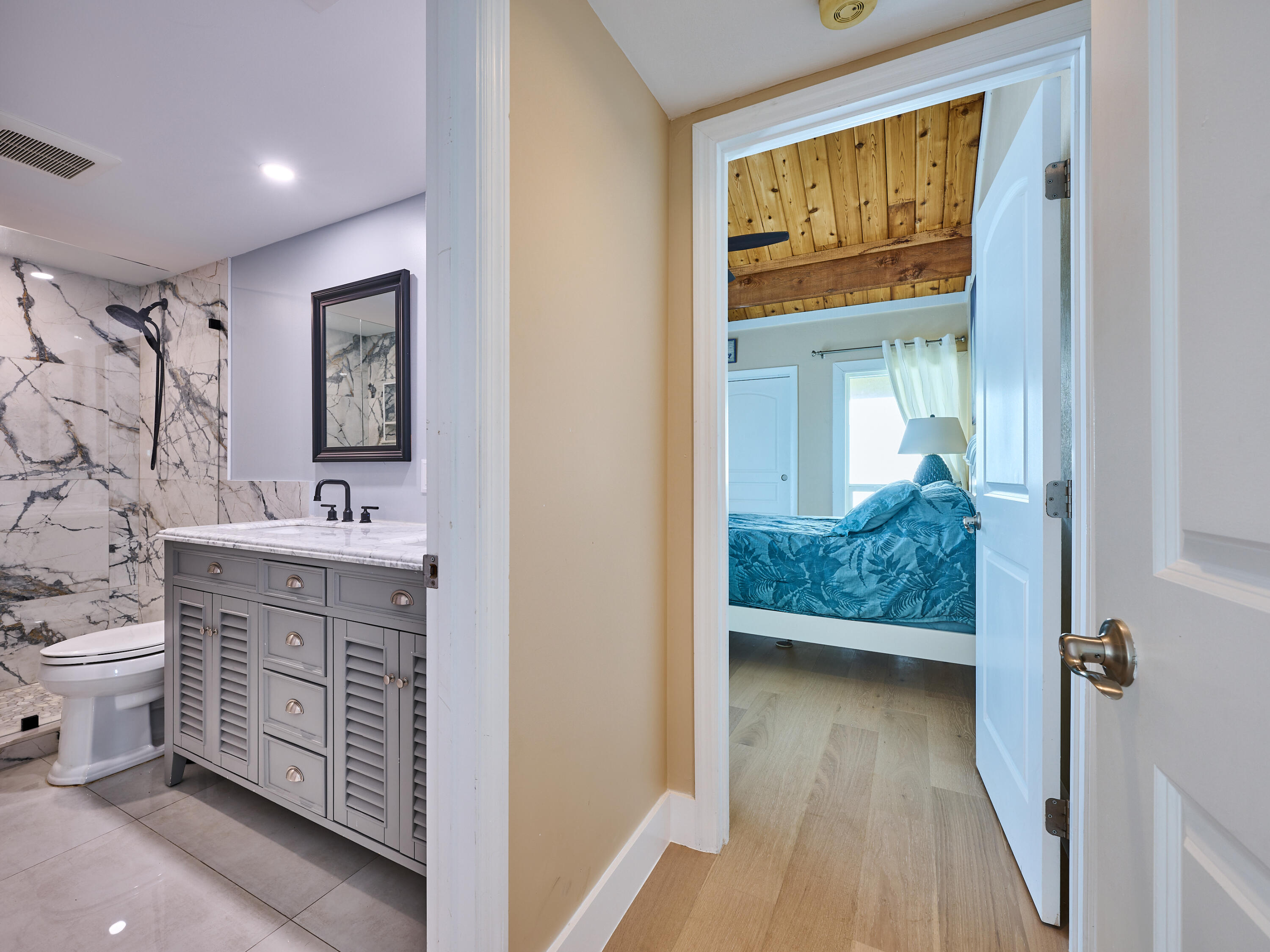 Undisclosed Address Jupiter, FL 33477 - Photo 10 of 20 a bathroom with a sink a mirror and a toilet