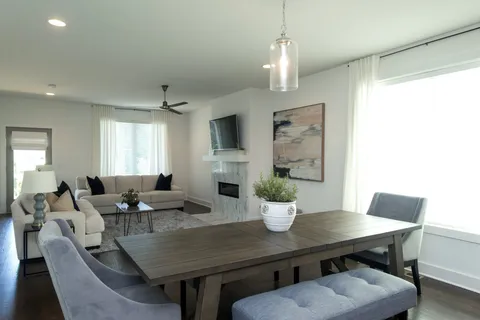a view of a dining room with furniture window and wooden floor