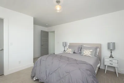 a bedroom with a bed and a lamp