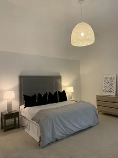 a bedroom with a bed and a chandelier
