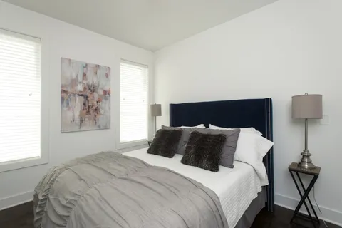 a bedroom with a bed and window