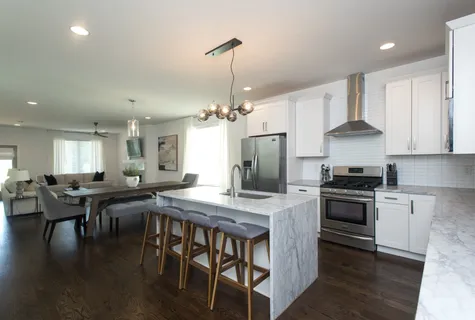 a kitchen with stove and wooden floor
