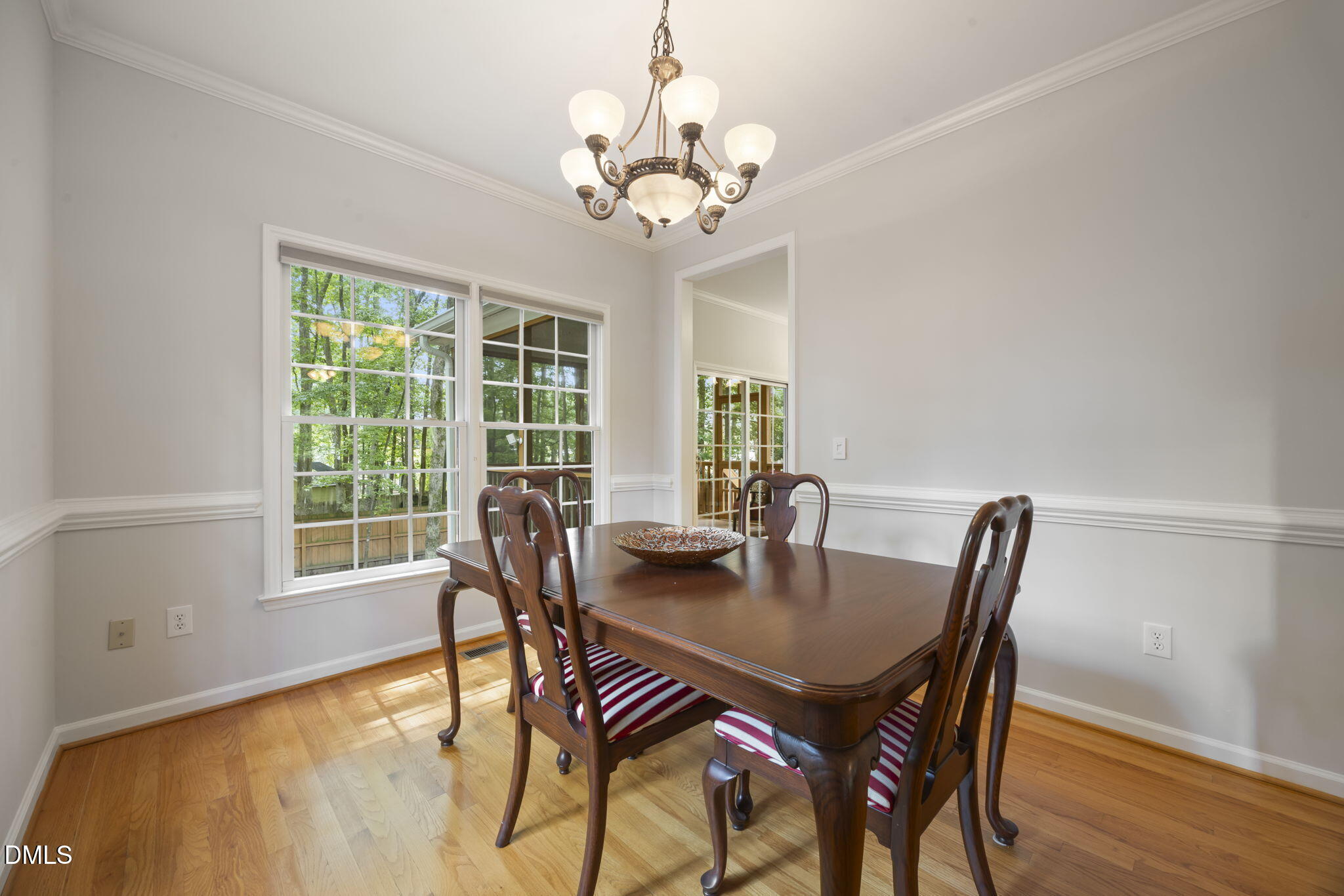 1008 Scotts Ridge Trail Apex, NC 27502 - Photo 19 of 57 a view of a dining room with furniture window and wooden floor