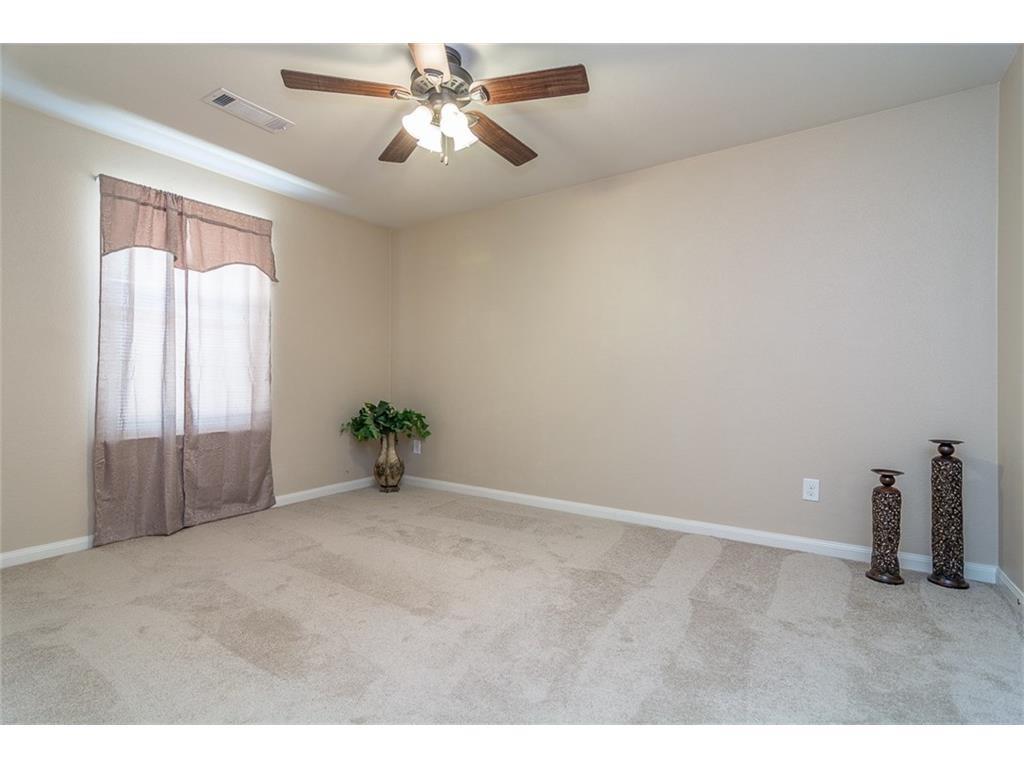 1009 Hawthorne Road Anna, TX 75409 - Photo 3 of 22 Neutral-toned room with light-colored carpeting, a window, and a ceiling fan with wood-finish blades