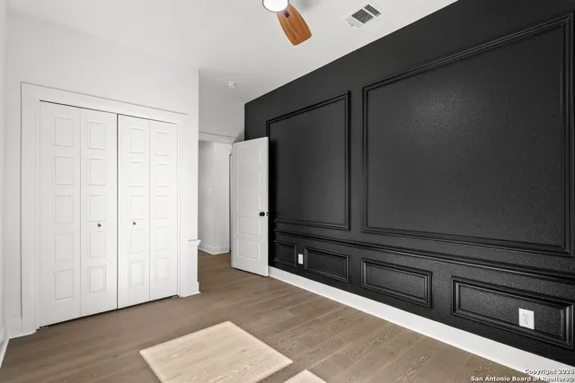 a view of a closet area with wooden floor