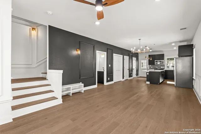 a view of kitchen with refrigerator stove and wooden floor