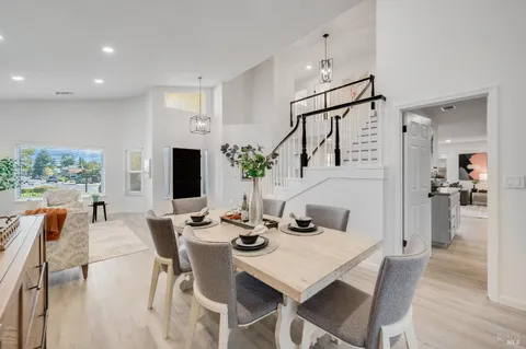 a kitchen with stainless steel appliances granite countertop a refrigerator a stove and a sink