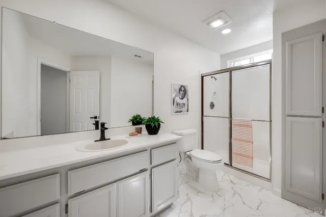 a bedroom with a bed a couch and a window