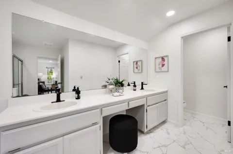 a view of a patio with table and chairs potted plants with wooden floor and fence