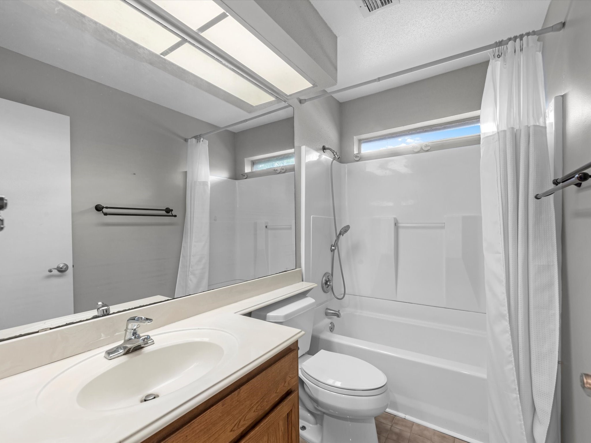 7735 Leafbrook Lane Spring, TX 77379 - Photo 19 of 27 a bathroom with a sink a toilet and shower