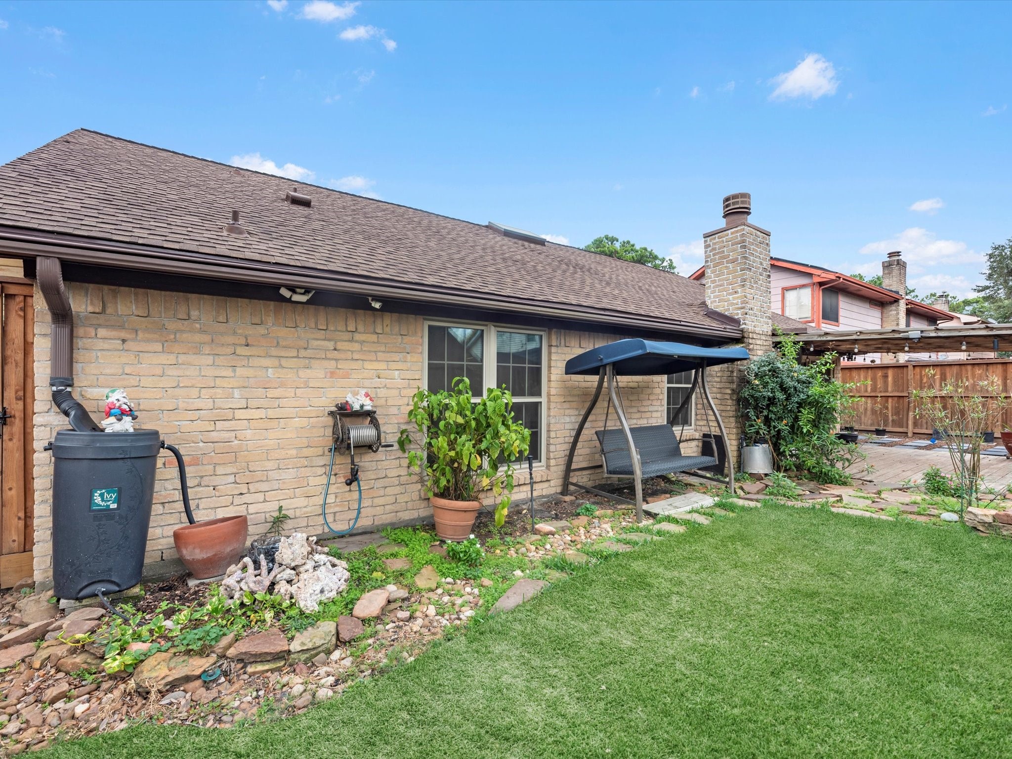 7735 Leafbrook Lane Spring, TX 77379 - Photo 25 of 27 a view of a chair and table in backyard of the house