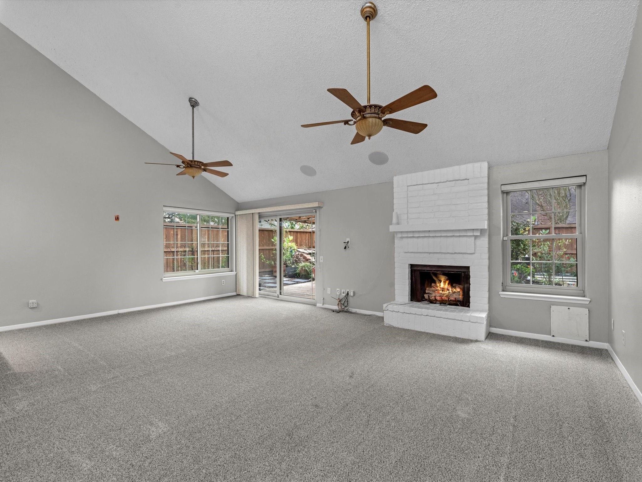 7735 Leafbrook Lane Spring, TX 77379 - Photo 4 of 27 a view of empty room with fireplace and windows