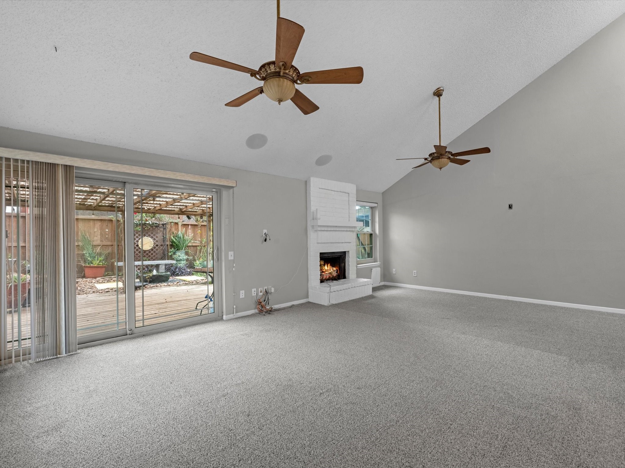 7735 Leafbrook Lane Spring, TX 77379 - Photo 7 of 27 an empty room with fireplace and windows