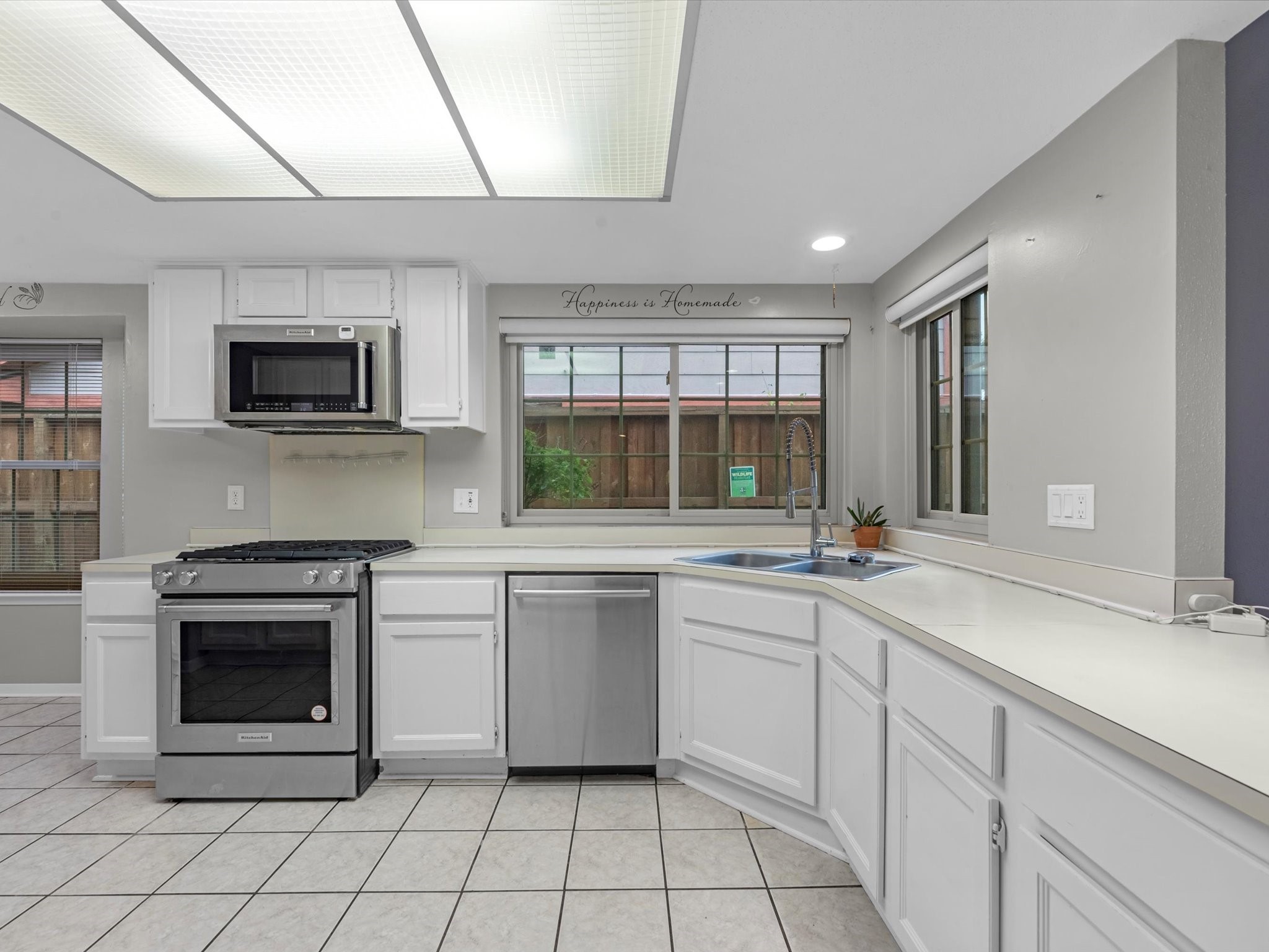 7735 Leafbrook Lane Spring, TX 77379 - Photo 8 of 27 a kitchen with a stove sink and microwave