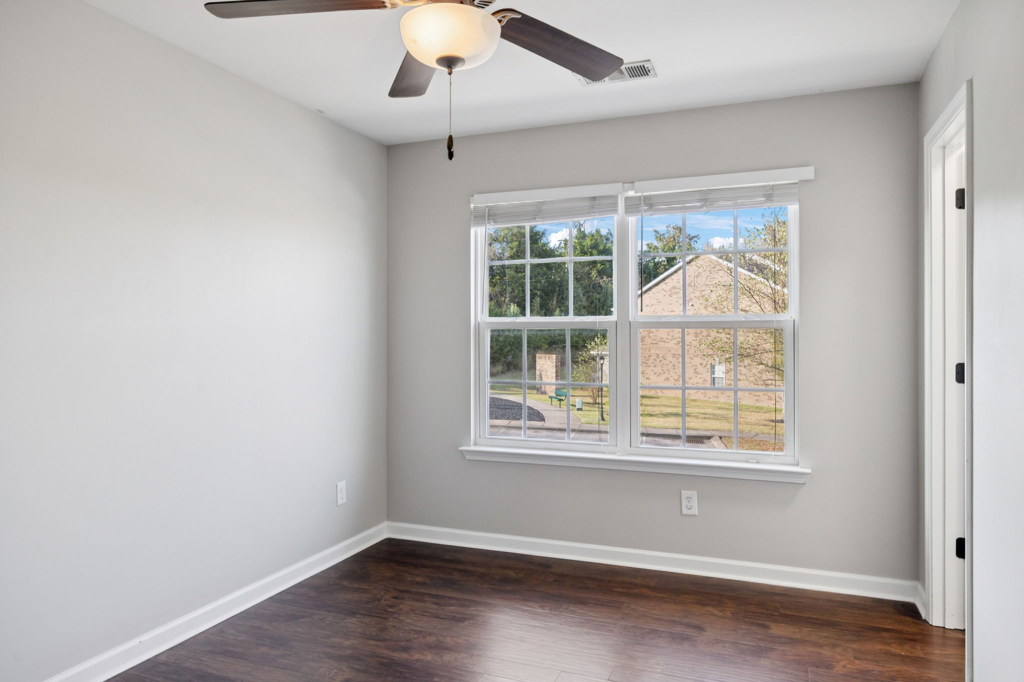 102 Cobblestone Pl Drive Goodlettsville, TN 37072 - Photo 12 of 15 an empty room with wooden floor fan and windows