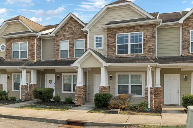 a front view of a house with garden and porch