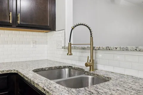 a kitchen with a sink and a mirror