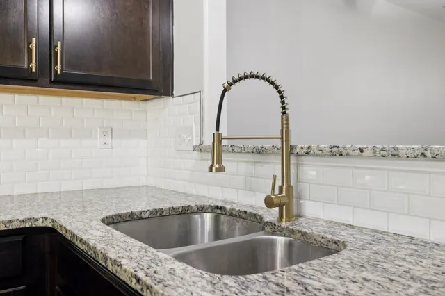 a kitchen with a sink and a mirror