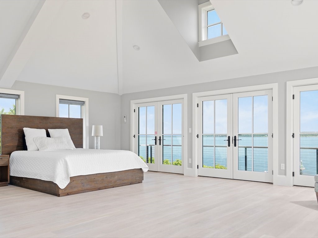 1058 East Shore Road Jamestown, RI 02835 - Photo 11 of 18 Spacious bedroom features a dramatic vaulted ceiling and French doors opening to a waterfront deck