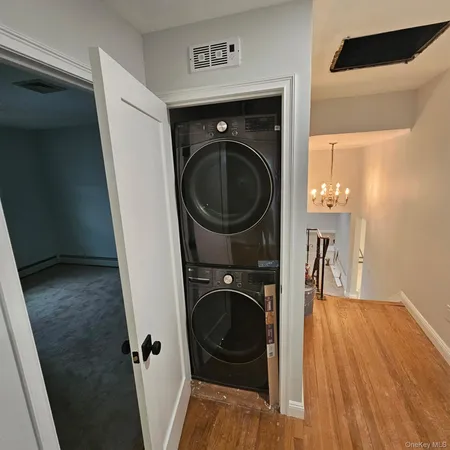 a view of a hallway with washer and dryer