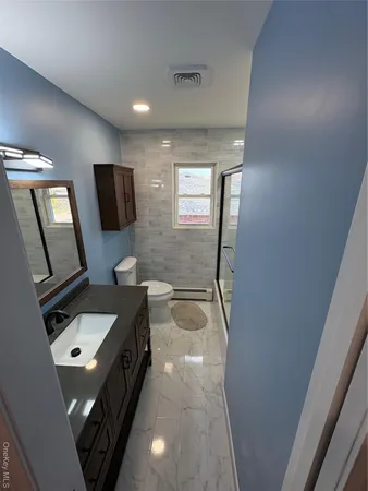 a bathroom with a sink a mirror and a toilet