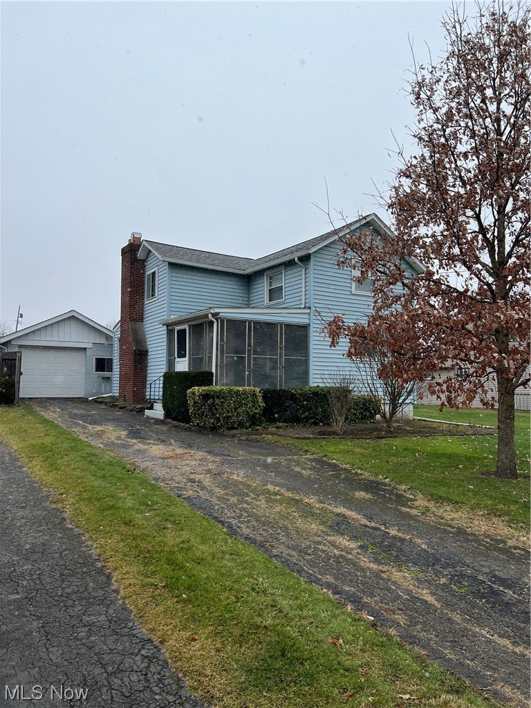 545 7th Street Struthers, OH 44471 - Photo 1 of 17 View of front of home featuring a garage and a front lawn