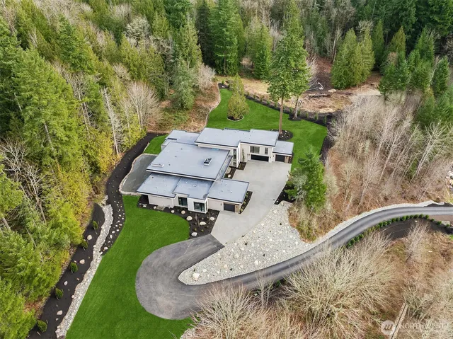 an aerial view of a house with outdoor space